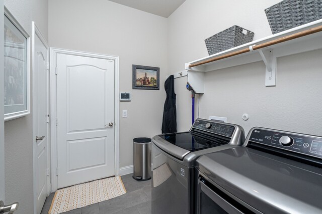 laundry room with tile patterned floors, laundry area, and washer and clothes dryer