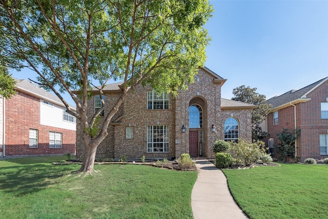 traditional home featuring brick siding and a front lawn