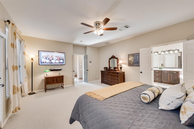 bedroom with light carpet, ensuite bath, visible vents, and baseboards