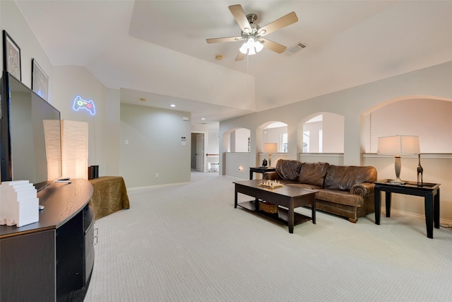 living area featuring light carpet, vaulted ceiling, visible vents, and baseboards