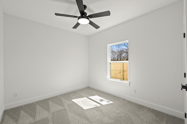 unfurnished room featuring baseboards, a ceiling fan, and light colored carpet