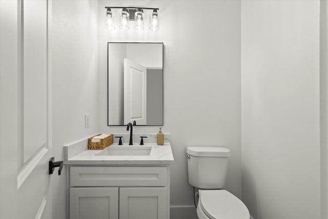 bathroom featuring toilet and vanity