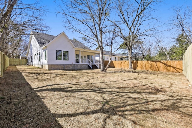 view of property exterior with a porch and a fenced backyard