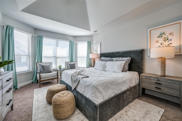 carpeted bedroom with multiple windows and baseboards