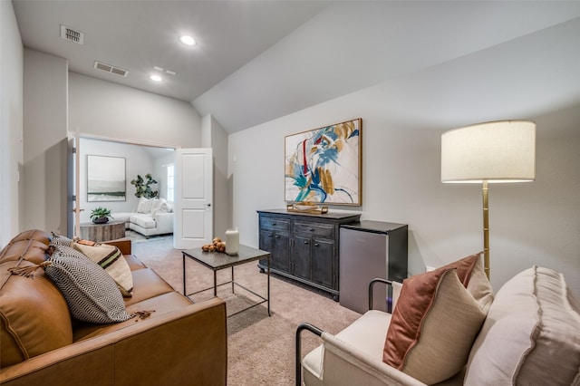 living room with light carpet, visible vents, vaulted ceiling, and recessed lighting