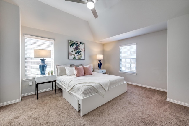 carpeted bedroom with vaulted ceiling, ceiling fan, and baseboards