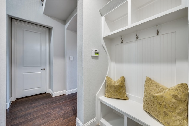 mudroom featuring dark wood-style flooring and baseboards