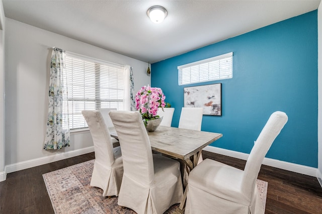 dining space with wood finished floors and baseboards