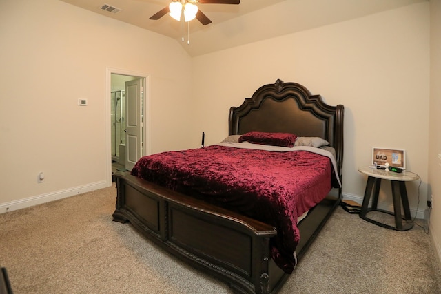 bedroom featuring carpet floors, visible vents, connected bathroom, vaulted ceiling, and baseboards