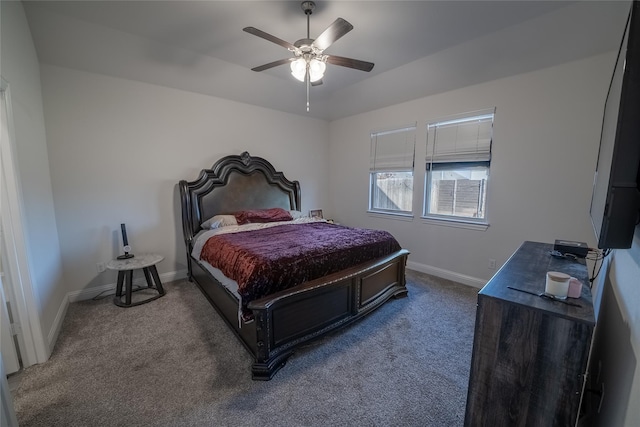 carpeted bedroom featuring baseboards and a ceiling fan