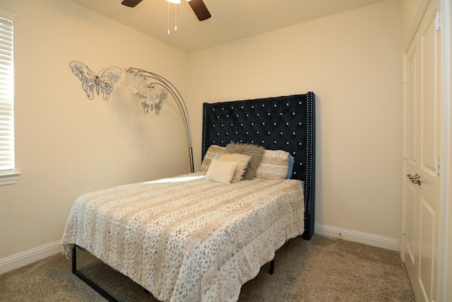 carpeted bedroom with a ceiling fan and baseboards