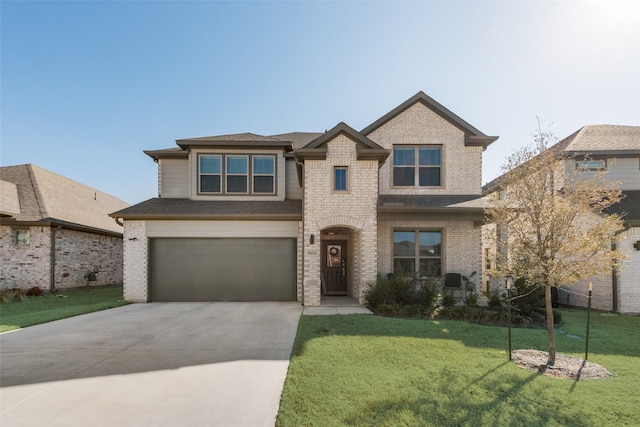 view of front of house featuring a garage, brick siding, driveway, and a front lawn