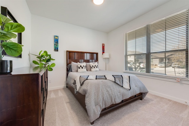 bedroom with carpet floors and baseboards