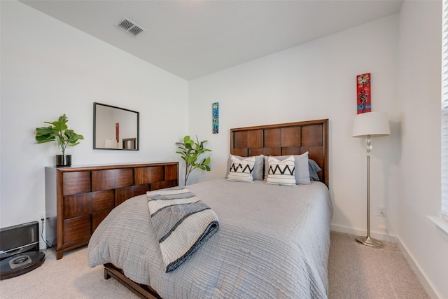 carpeted bedroom with visible vents and baseboards