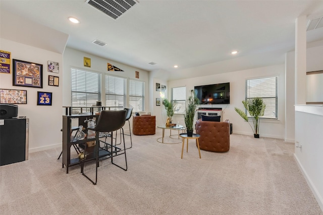 living room with a healthy amount of sunlight, carpet, and visible vents