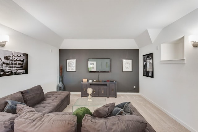 living room featuring light colored carpet, vaulted ceiling, and baseboards