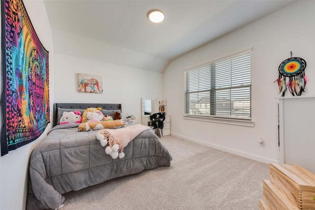 bedroom with carpet, lofted ceiling, and baseboards