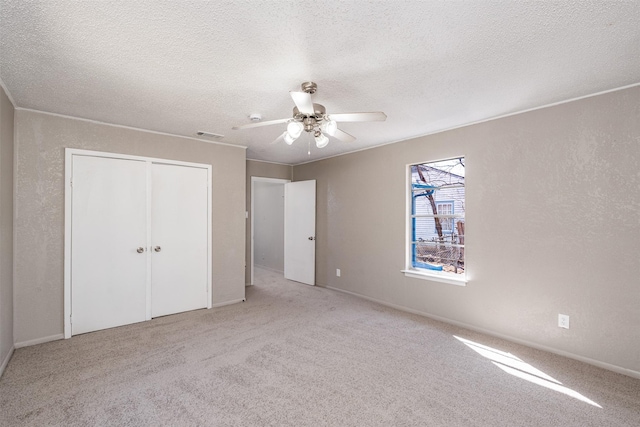 unfurnished bedroom featuring a textured ceiling, a textured wall, and crown molding