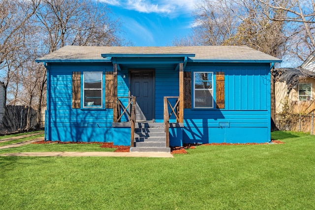 bungalow-style house with fence and a front yard