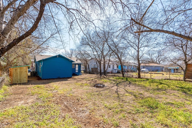 view of yard with an outdoor structure and fence