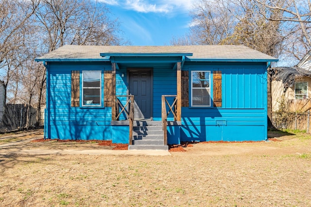 bungalow-style home featuring a front yard