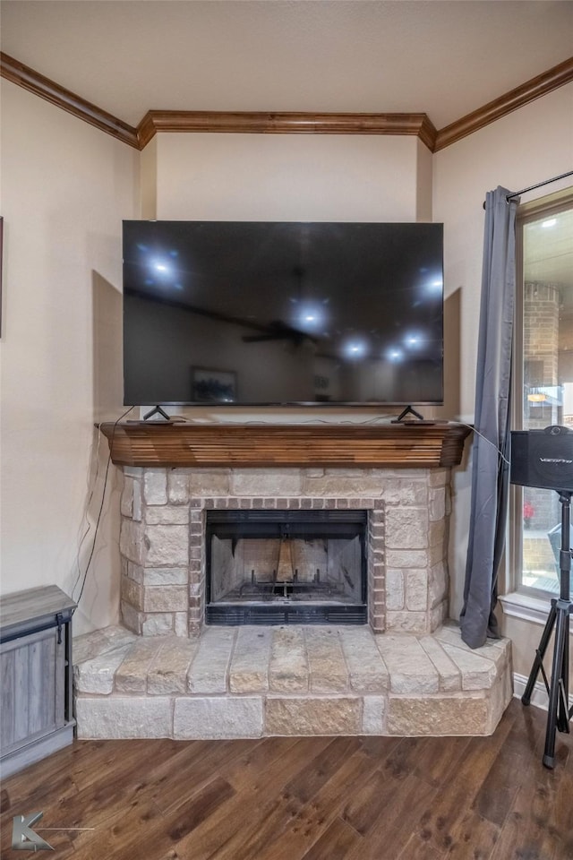 details with baseboards, a stone fireplace, wood finished floors, and crown molding