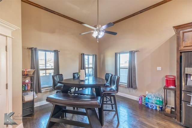 dining area with plenty of natural light, ornamental molding, and dark wood-style flooring