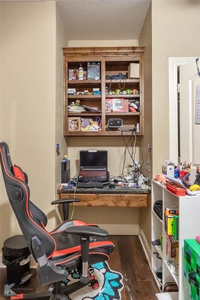 office space with baseboards and dark wood finished floors