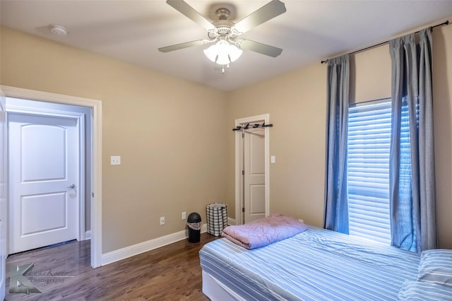 bedroom featuring a ceiling fan, baseboards, and wood finished floors