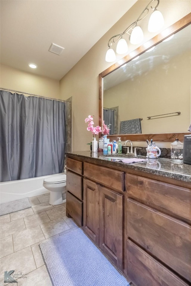 bathroom featuring visible vents, shower / tub combo with curtain, vanity, and toilet