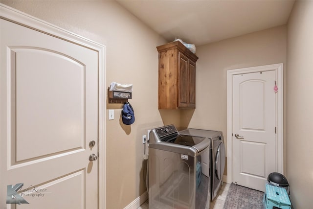 washroom featuring cabinet space, light tile patterned floors, and independent washer and dryer