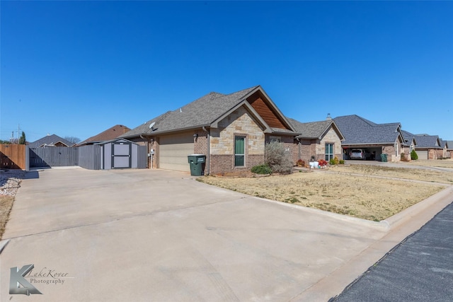 view of front facade with an attached garage, brick siding, fence, concrete driveway, and stone siding