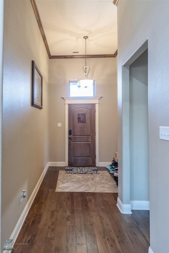 entrance foyer featuring baseboards, ornamental molding, and dark wood finished floors