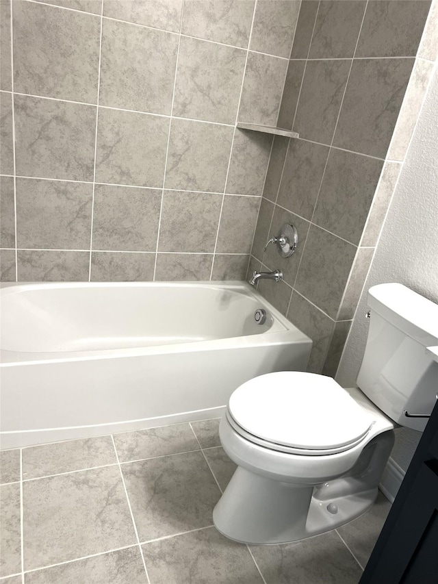 bathroom with shower / washtub combination, tile patterned flooring, and toilet