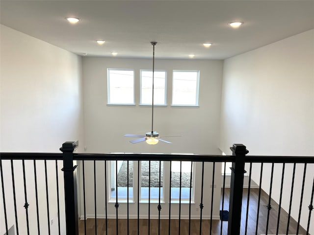 corridor with baseboards, dark wood-style flooring, and recessed lighting