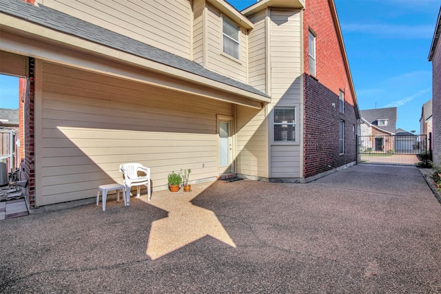 back of house with brick siding and a patio