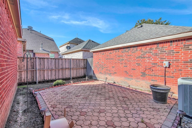 view of yard featuring central AC, a patio area, and a fenced backyard