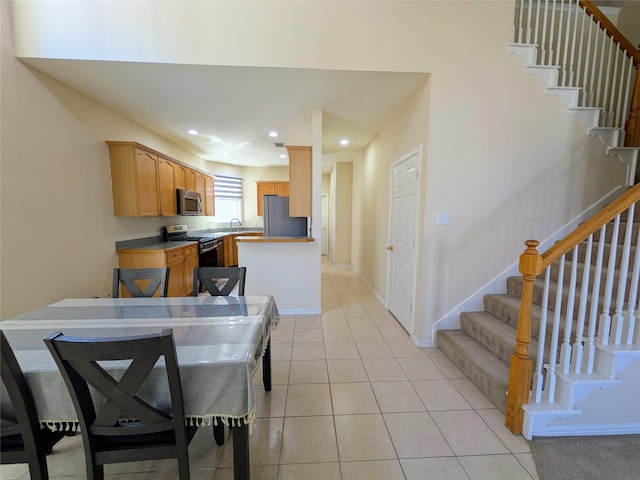 dining area featuring light tile patterned floors, stairs, baseboards, and recessed lighting