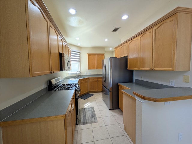 kitchen with light tile patterned flooring, recessed lighting, a sink, visible vents, and appliances with stainless steel finishes