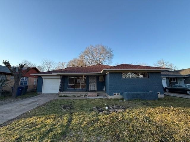 ranch-style home with brick siding, a porch, a garage, driveway, and a front lawn