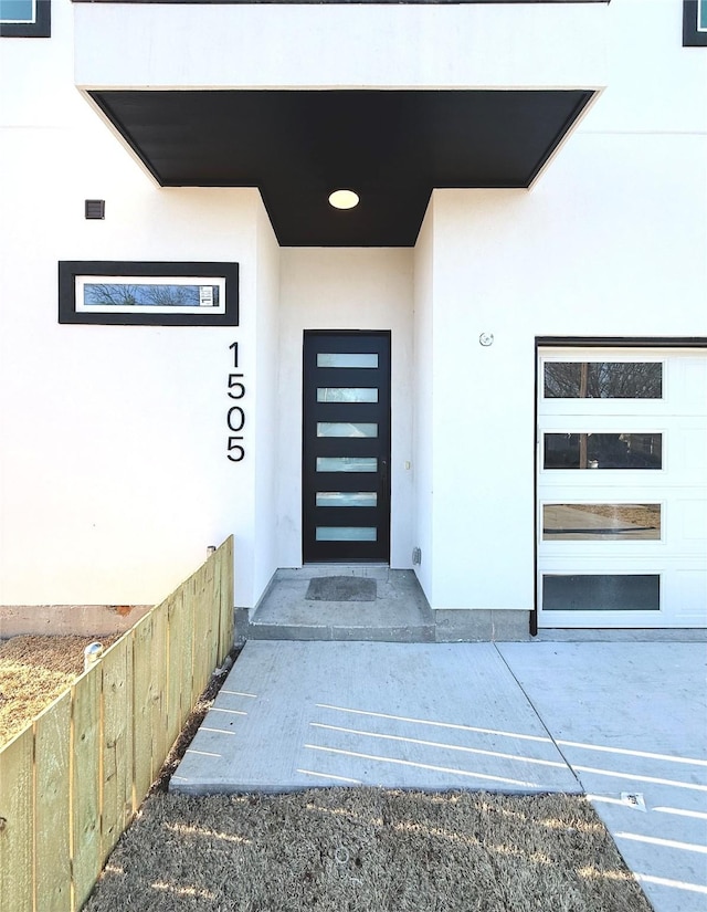 entrance to property featuring stucco siding