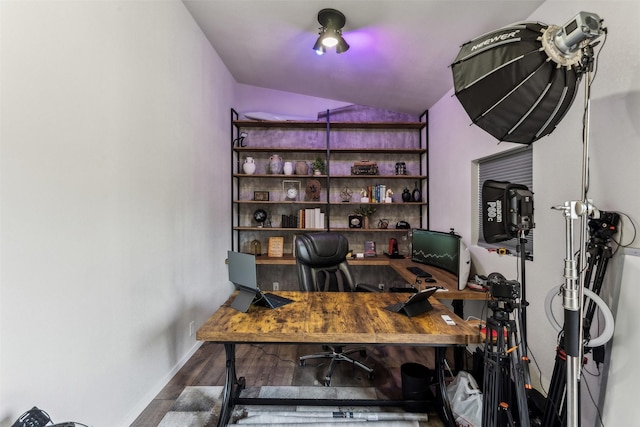 home office featuring lofted ceiling, baseboards, and wood finished floors