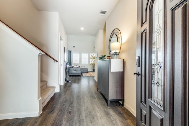 entrance foyer with baseboards, stairs, visible vents, and dark wood-style flooring