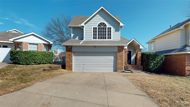 traditional home with brick siding, driveway, an attached garage, and roof with shingles