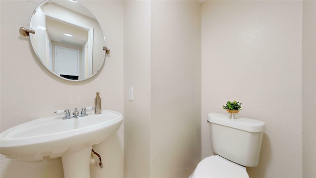 bathroom featuring toilet and a sink