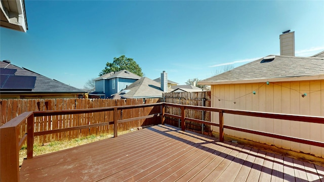 wooden terrace featuring fence