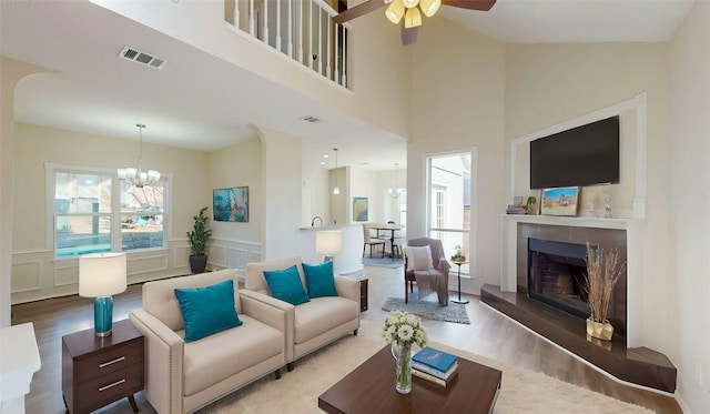 living area with a wealth of natural light, wood finished floors, and visible vents