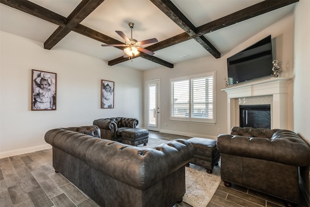 living room with wood tiled floor, baseboards, beam ceiling, and a glass covered fireplace