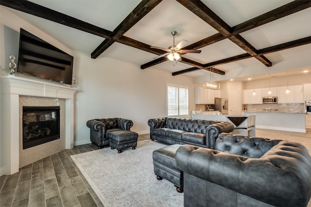 living room with baseboards, coffered ceiling, a premium fireplace, wood finish floors, and beam ceiling