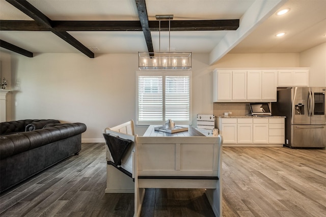 dining space with baseboards, wood finished floors, beam ceiling, and recessed lighting